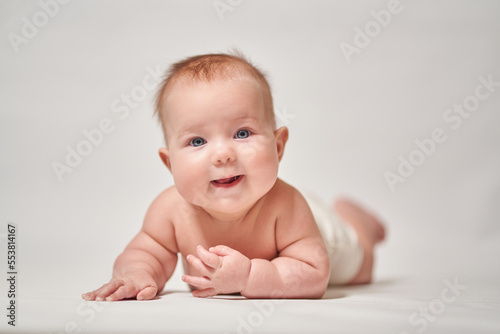 baby's smile. baby lying on his stomach looking at the camera