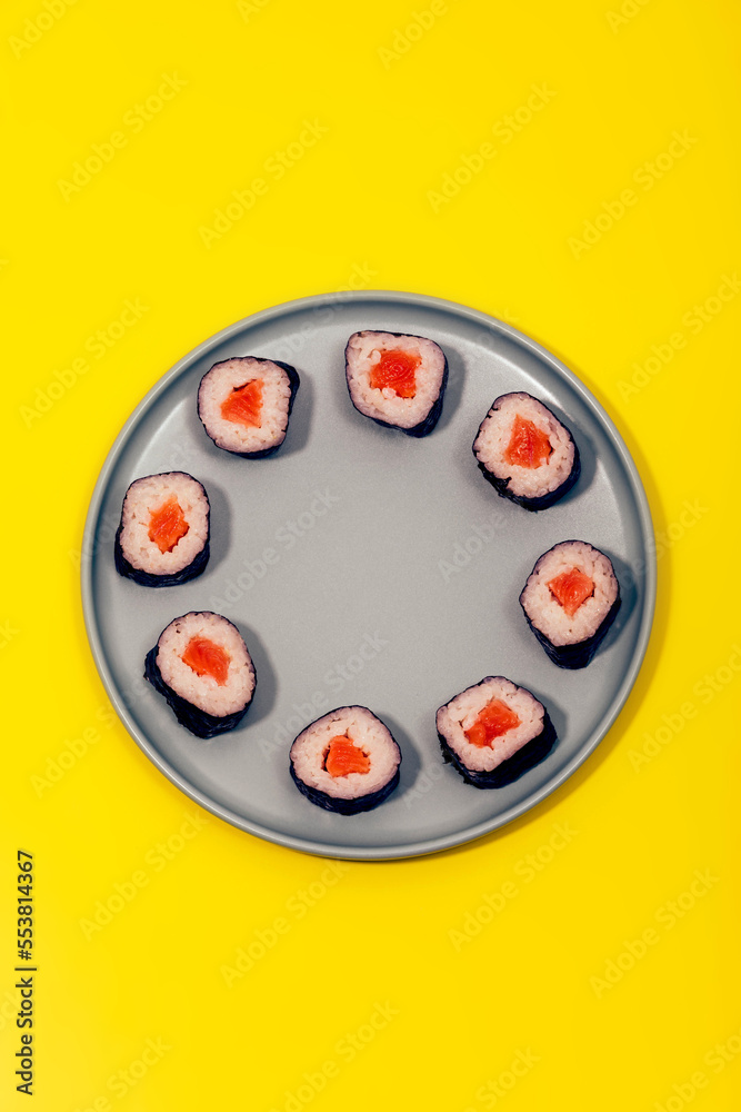 Appetizing rolls with salmon rice and nori served on plate Appetizing rolls with salmon rice and nori served on plate