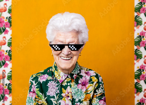 Confident elderly female in pixel sunglasses photo
