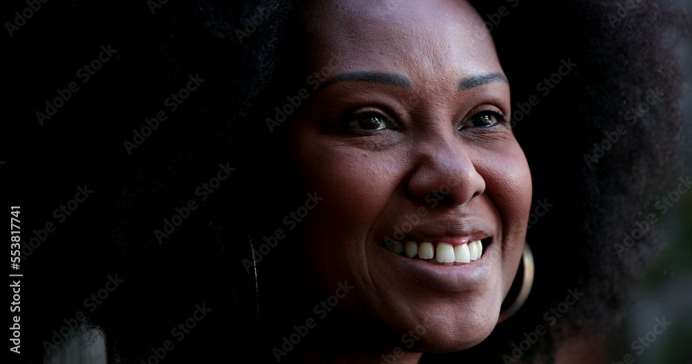 Positive African woman smiling. Black person portrait face close-up Positive African woman smiling. Black person portrait face close-up