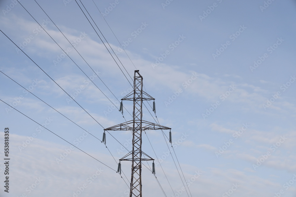 Overhead high voltage power line. Cloudy sky and copy space, energy crisis.