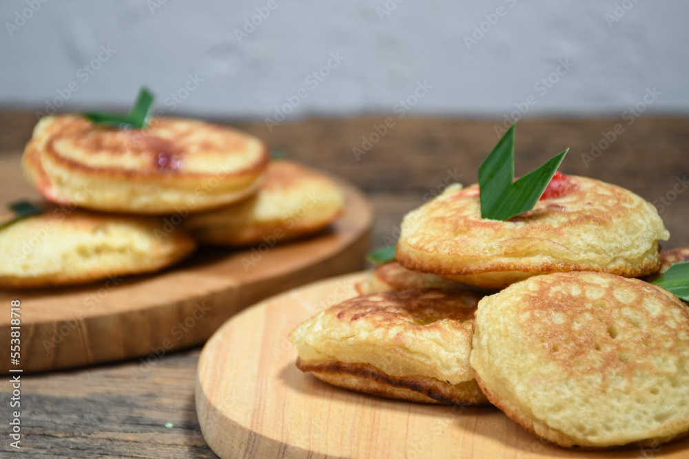Kue Khamir or samir or Khamir cake on wooden plate. Khamir cake is a traditional snack from Pemalang, Indonesia. This cake is made from flour, butter and egg dough. Selective Focus