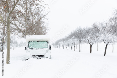 Family motor home trapped after snow storm. Winter landscape, weather, road trip.