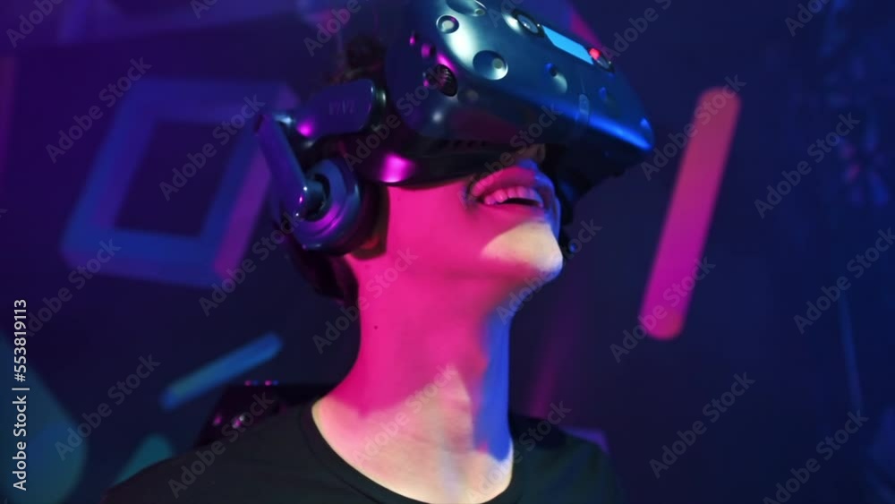 Close view of a joyful, smiling boy is playing on VR treadmill using helmet. Slow motion Close view of a joyful, smiling boy is playing on VR treadmill using helmet. Slow motion