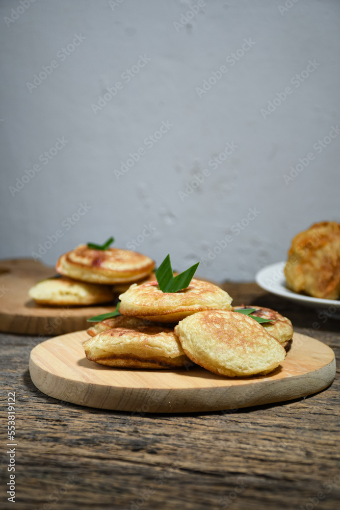 Kue Khamir or samir or Khamir cake on wooden plate. Khamir cake is a traditional snack from Pemalang, Indonesia. This cake is made from flour, butter and egg dough. Selective Focus