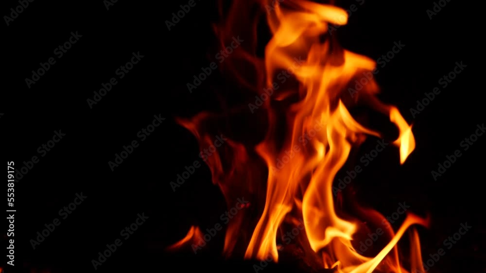 Zoomed in video of blazing fire yellow flame effect in darkness Zoomed in video of blazing fire yellow flame effect in darkness