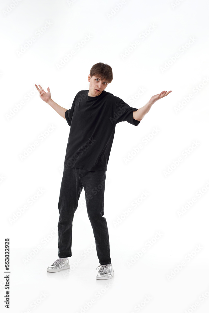 young man in black t-shirt and jeans dancing young man in black t-shirt and jeans dancing