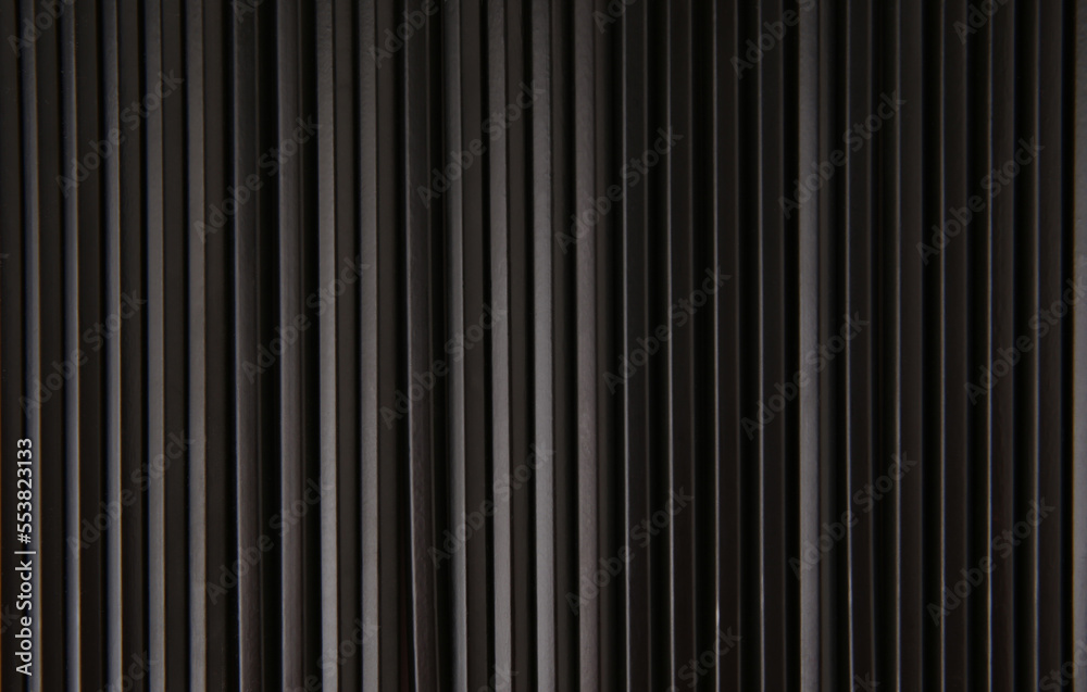 Black striped background of pencils lined up in row. Wooden texture background. Copy space.