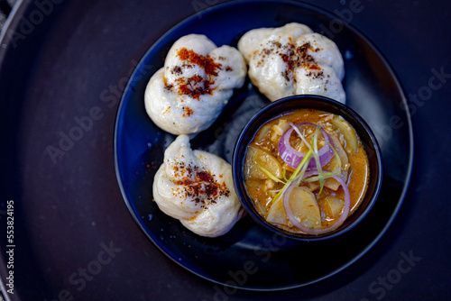 Tibetan dumplings (ting momo) served on a plate with dipping sauce 