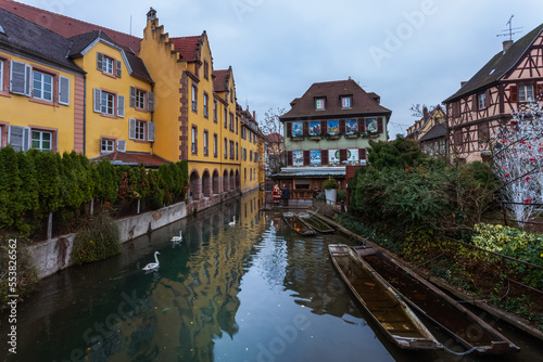 Traditional houses of the Alsace region in the twilight sky. Fishing boats on the water channel of the old town of Colmar. France.Christmas.