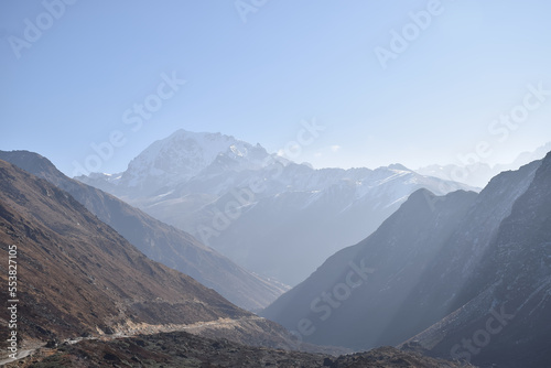 Panoramic landscape view of the majestic snowcapped Himalayas mountain range on a foggy winter morning in North Sikkim, Sikkim, India