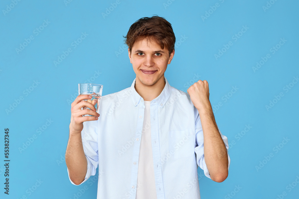 Young handsome man with drinking glass of water Young handsome man with drinking glass of water