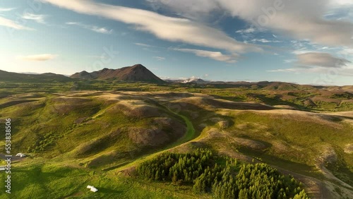 Volcanic hills covered with green vegetation Iceland aerial sunset countryside photo