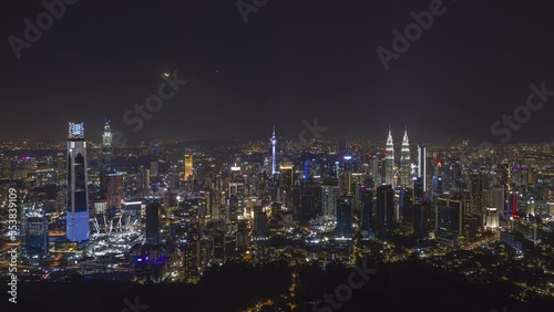 Wallpaper Mural Aerial high angle night view time lapse overlooking busy city streets and a moon setting against a city skyline in Kuala Lumpur, Malaysia. Prores 4KUHD Timelapse. Torontodigital.ca