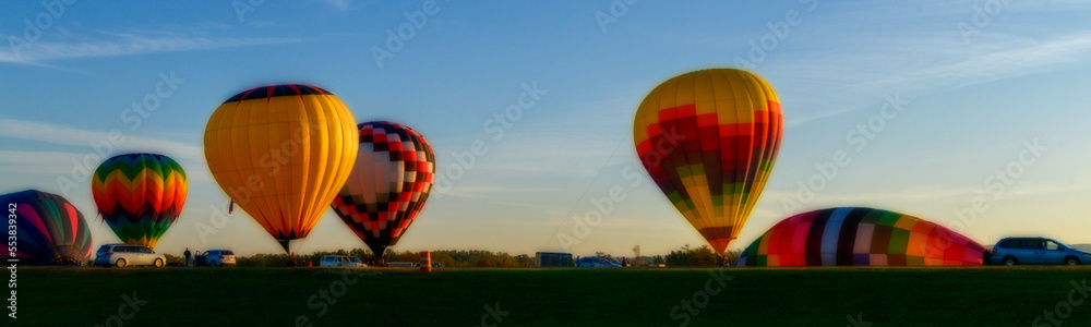 Obraz premium Hot Air Balloons lifting off in the morning