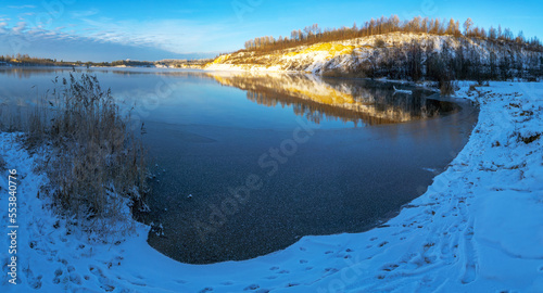 Fototapeta Naklejka Na Ścianę i Meble -  The first ice on the pond in the early frosty morning.