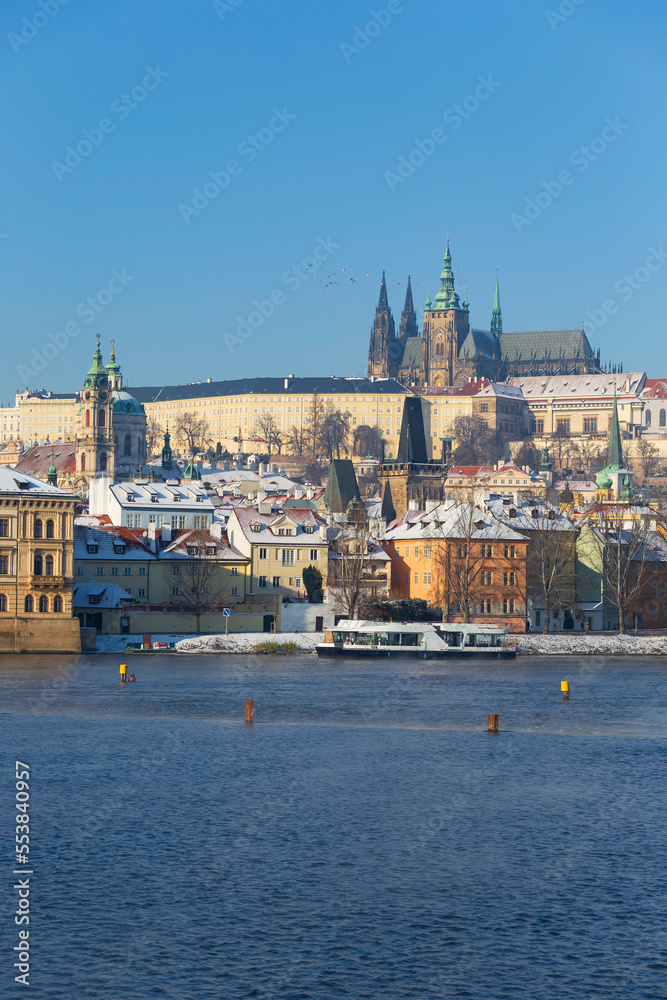 Snowy Prague Lesser Town with Prague Castle above River Vltava in the sunny Day , Czech republic