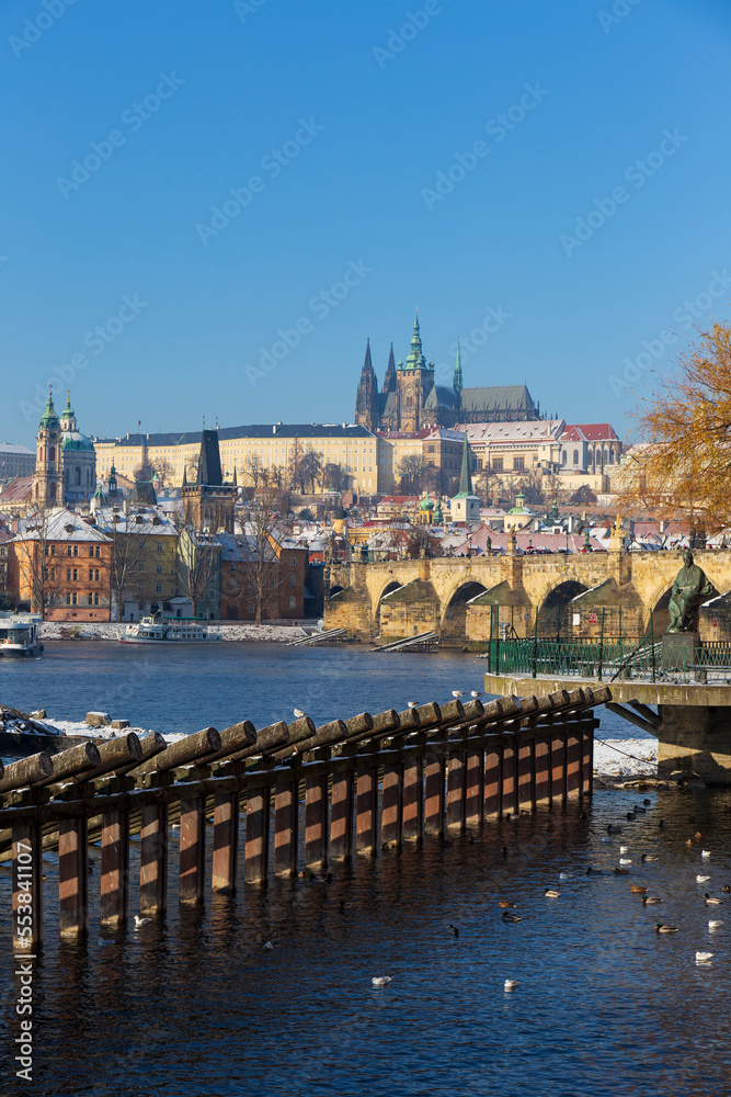 Fototapeta premium Snowy Prague Lesser Town with Prague Castle above River Vltava in the sunny Day , Czech republic
