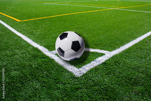 Soccer ball on the corner mark  synthetic grass