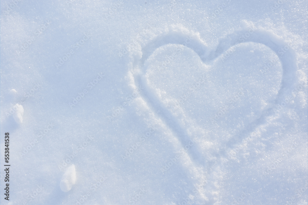 Heart painted on white fluffy snow with copy space