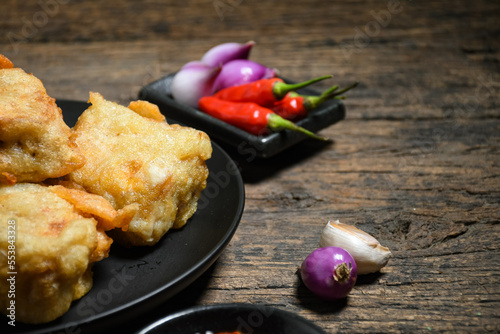 Gorengan or Fried tofu on a black plate. Fried food is one of the favorite snacks in Indonesia and chinna photo