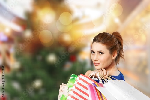 Young happy woman hold shopping bags