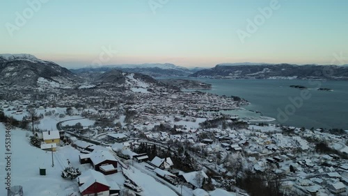 Sunset over Norwegian coastal landscape. Winter, mountains and fjord.