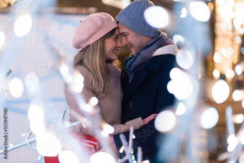 Slika na platnu Young happy attractive amorous couple embracing and kissing outdoor