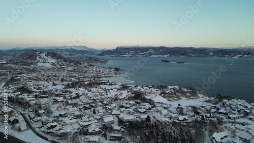 Sunset over Norwegian coastal landscape. Winter, mountains and fjord.