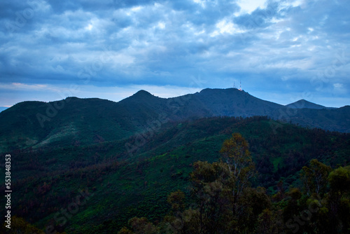 mountains in blue hour with cloudy sky and green vegetation, sierra de guadalupe in state of mexico photo