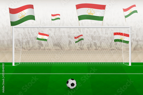 Tajikistan football team fans with flags of Tajikistan cheering on stadium, penalty kick concept in a soccer match.