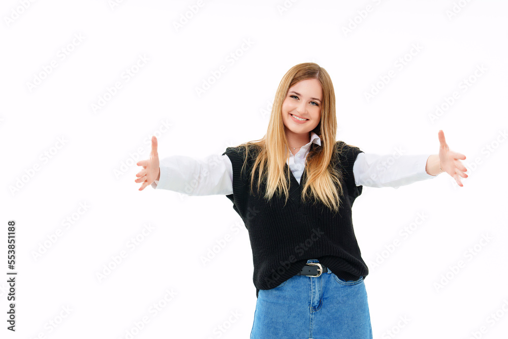 a blonde in a black vest extends his open arms forward on a white background a blonde in a black vest extends his open arms forward on a white background