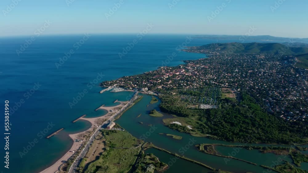 River l'Argens joining the mediterranean sea Saint Aygulf city in background sunny day aerial River l'Argens joining the mediterranean sea Saint Aygulf city in background sunny day aerial