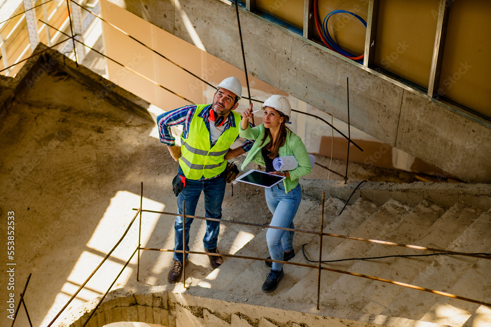 Architect and foreman meeting at construction site,Architect inspects the construction site,Construction project concept. Architect and foreman meeting at construction site,Architect inspects the construction site,Construction project concept.