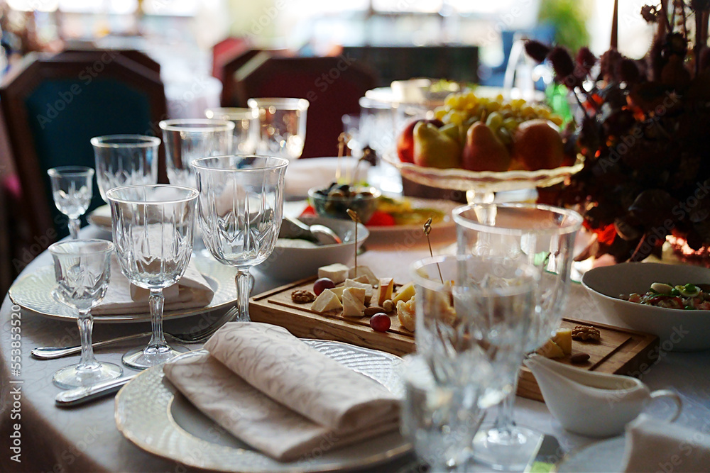 table setting for a festive dinner. empty wine glasses, tableware and snacks. table setting for a festive dinner. empty wine glasses, tableware and snacks.
