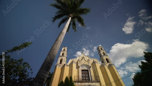 Slow turning view to the right of Cathedral of San Juan in Merida, Yucatan Mexico with a clear blue sky on sunny day. photo