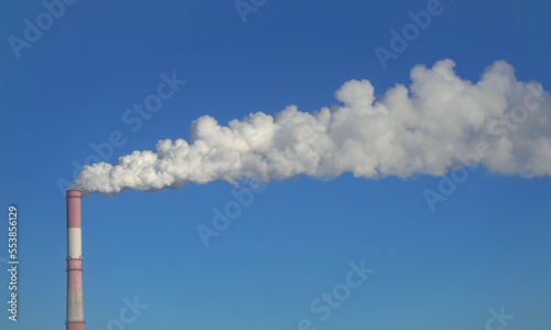 Chimney of factory and clear blue sky, environmental pollution
