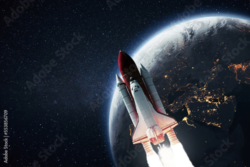 Leinwand Poster Rocket shuttle takes off from the planet earth into starry space