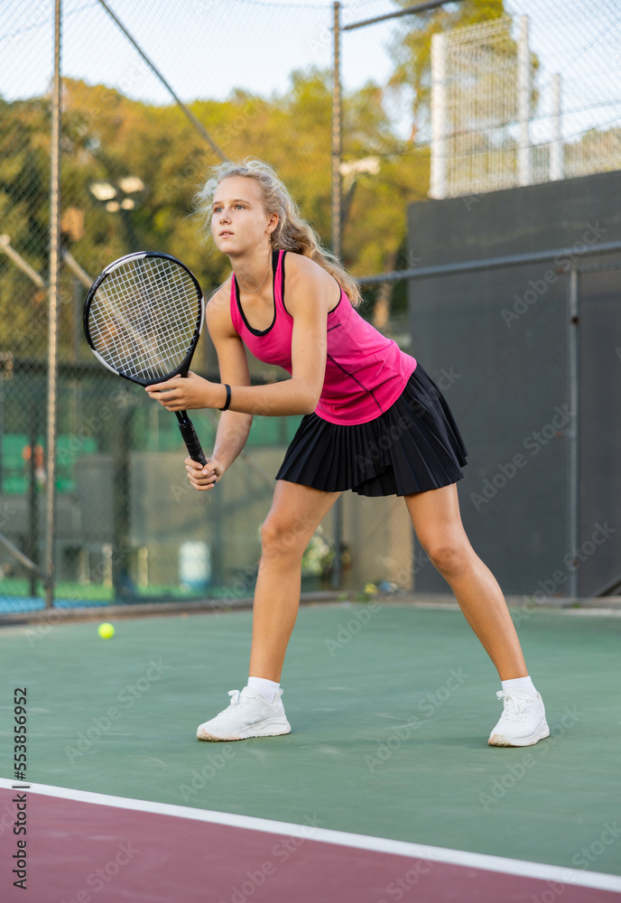 Young woman in skirt playing tennis on court. Racket sport training  outdoors. Stock Photo | Adobe Stock