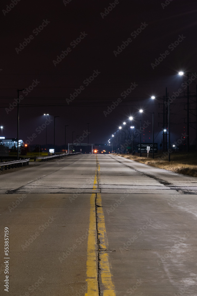 Long exposure of road lit by streetlights.