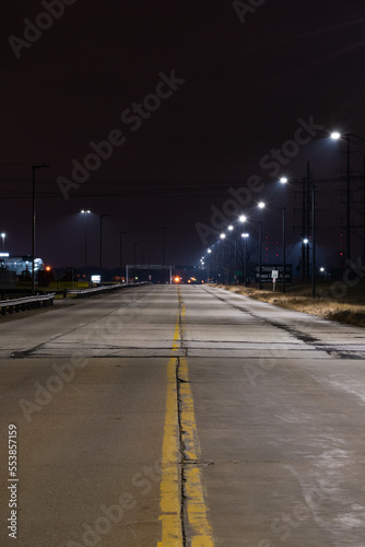 Long exposure of road lit by streetlights. © Albert Jackson
