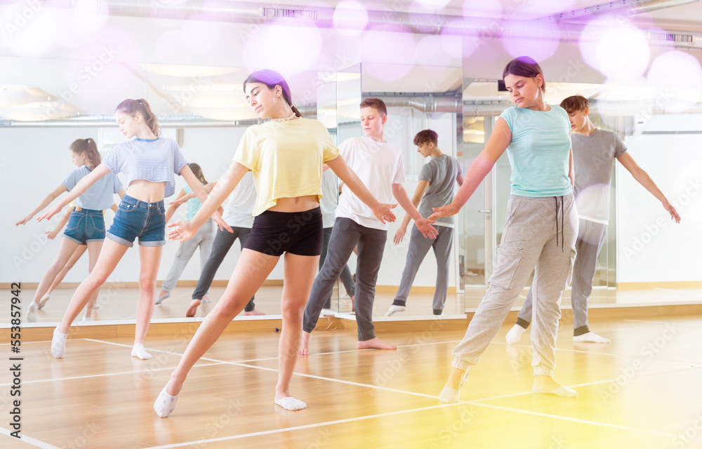 Group of teenage boys and girls enjoying dance class together
