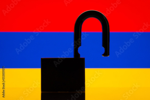 Black silhouette of open lock against flag of Armenia. Reopen Armenia country, freedom, easy pass of border concept photo