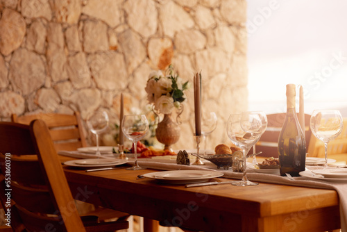 Konstfotografi Dinner wood table in outdoor garden with vine glass and boatle, sun light