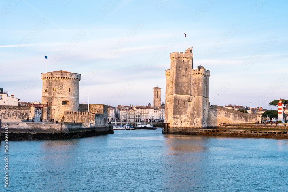 The port of La Rochelle during the blue hour. Panorama of the skyline with its famous towers. banner with copy space