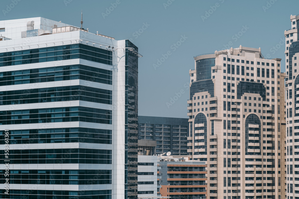 Shot of UAE's modernist architectural buildings featuring innovative exposed-glass walls like the building at the left and designs that offer subtle touch of traditional nods like the one at the right