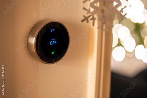 Smart Thermostat with Heat Off Status with Christmas decorations and fairy lights in background photo