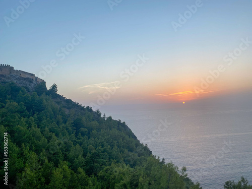 Tourist view from the mountain from a height to the peninsula seashore and green trees at sunset in Turkey on vacation in a paradise warm eastern tropical country resort