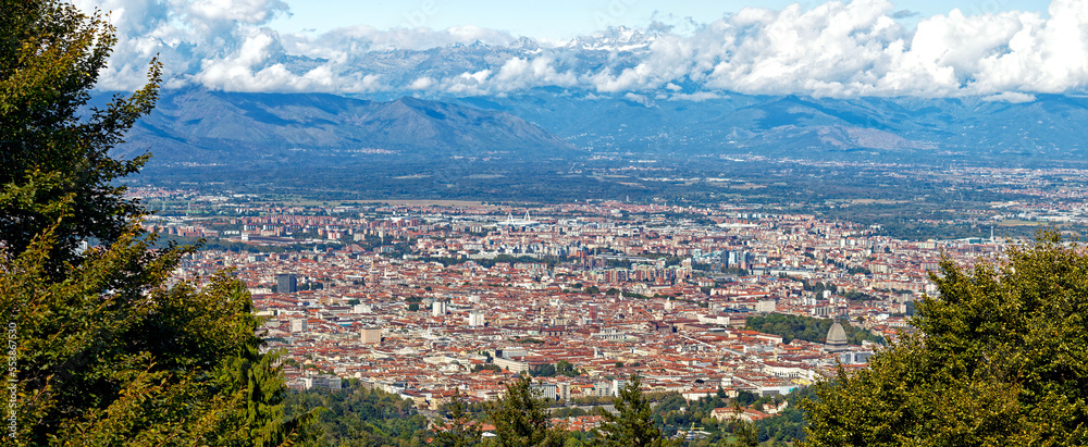 Aerial panorama of the historic center of Turin (Piedmont, Italy) seen from Colle della Maddalena with Alps on the background