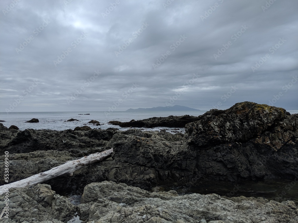 Island by rocky beach on a cloudy day Island by rocky beach on a cloudy day